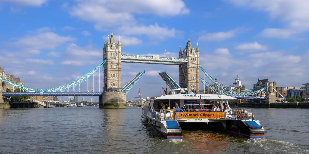 Thames Clipper boat heading for Tower Bridge in London 