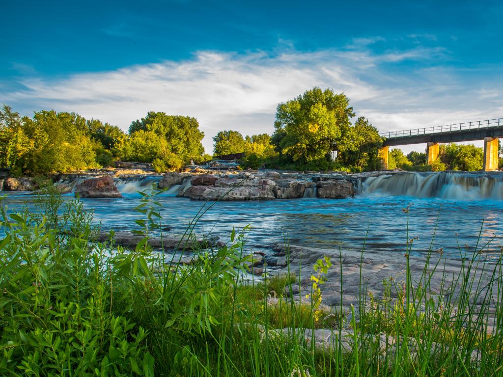 Sioux Falls, South Dakota, USA with a view of the falls and mill, trees in the background and taken on a sunny day.
