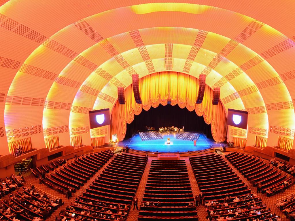 Stunning lit stage inside, with visitors awaiting the show at Radio City Music Hall