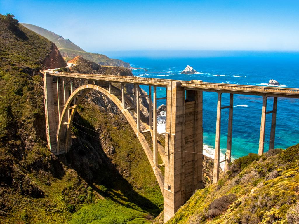 A view of Bixby Bridge in Big Sur, California looking out towards the ocean beyond.