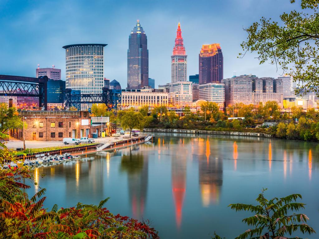 Cleveland, Ohio, USA skyline on the river taken at early evening with lights on the buildings in the distance.