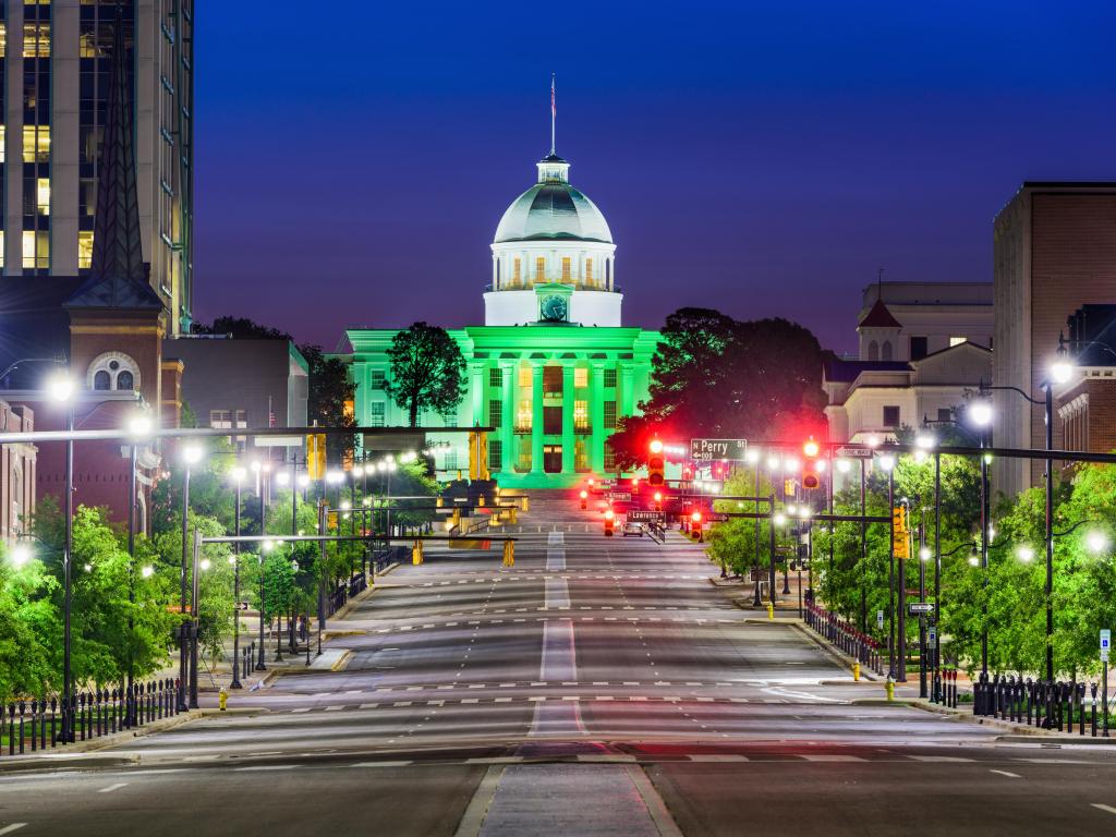 Montgomery, Alabama, USA with the State Capitol at night lit up in green.