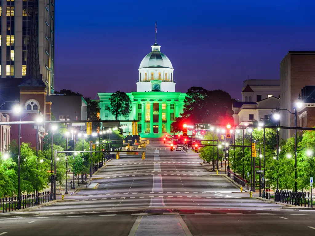 Montgomery, Alabama, USA with the State Capitol at night lit up in green.