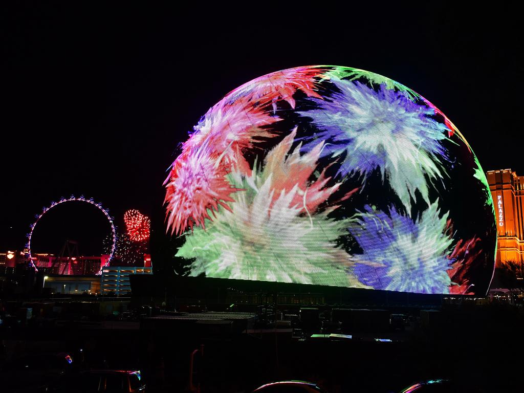 MSG Sphere Exosphere lit up at night in colorful projections