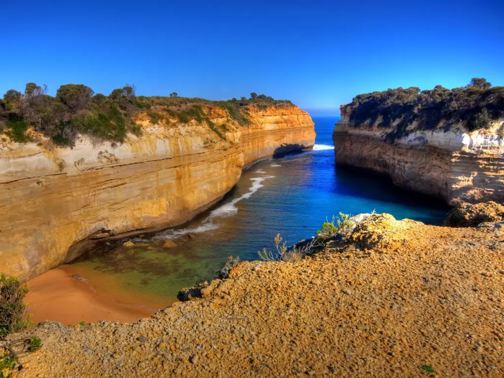 View over the impressive Thunder Cave, with sandstone cliffs and crashing waves, Great Ocean Road, Australia