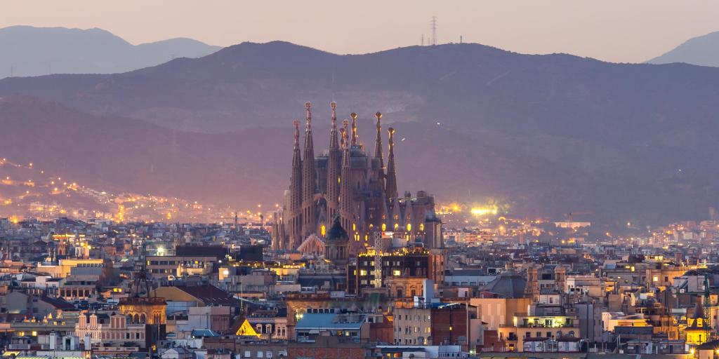 Sagrada Familia against the skyline of Barcelona, Spain, at dusk