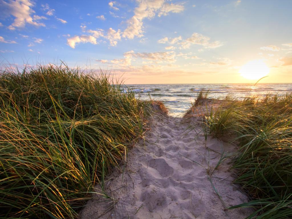 Path To A Summer Sunset Beach. Sandy beach trail leads to a sunny summer horizon over the open waters of Lake Michigan. Hoffmaster State Park. Muskegon, Michigan