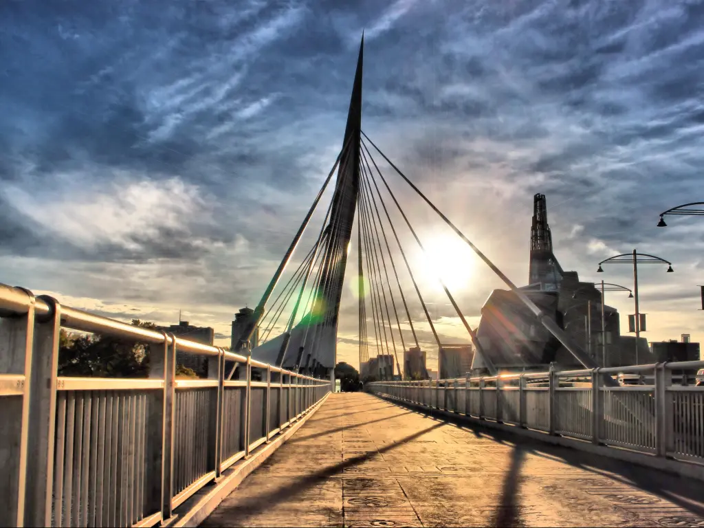 Winnipeg, Manitoba, Canada with a view of Provencher Bridge above the Red River, at The Forks at sunset.