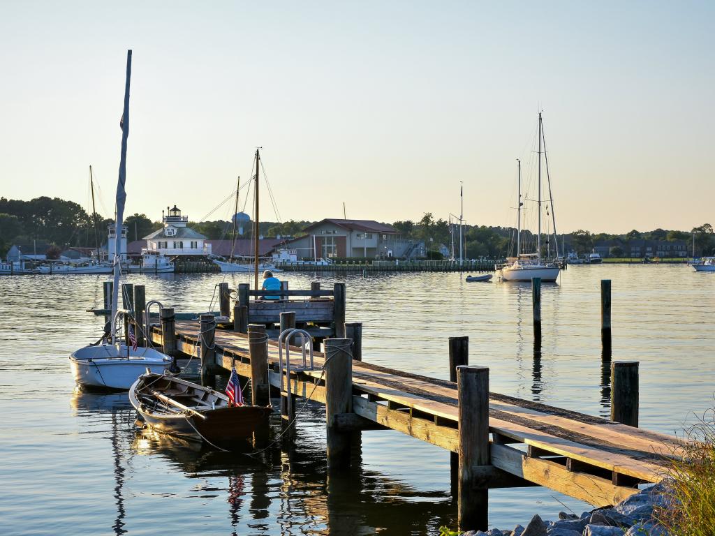 Small boats next to a small wooden jetty in the harbour at St. Michaels, Maryland
