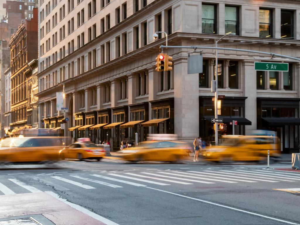 Busy intersection with yellow taxis on the Fifth Avenue