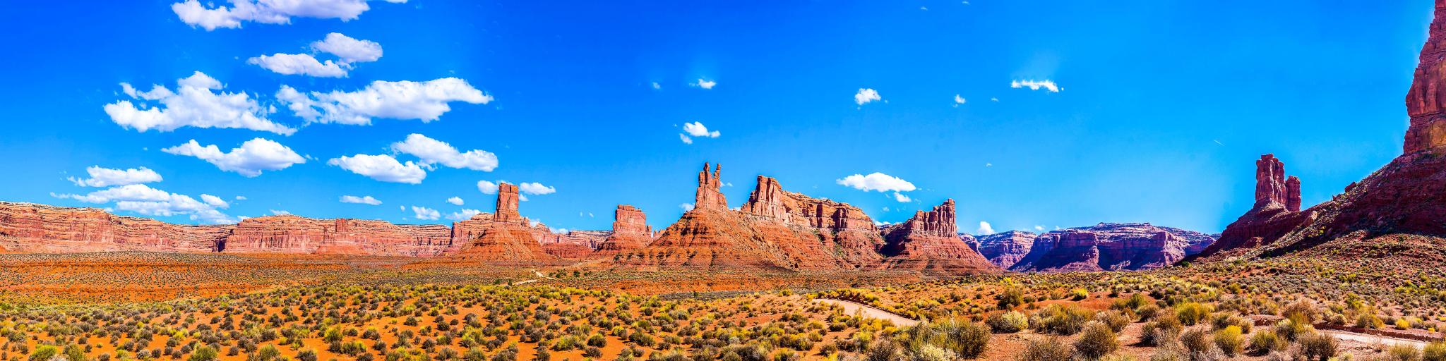 Red rock canyon desert in Nevada panoramic landscape against a blue sky.