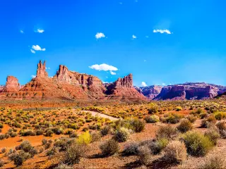 Red rock canyon desert in Nevada panoramic landscape against a blue sky.