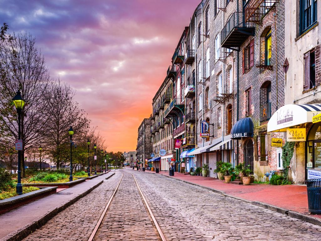 Shops and buildings on a cobbled street with tramlines