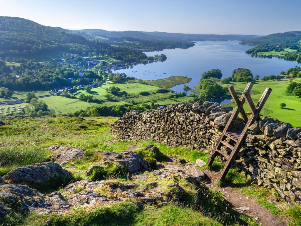 Lake Windermere, Lake District, UK with a morning shot of Lake Windermere showing the stone walling and the stile providing passage over the wall.