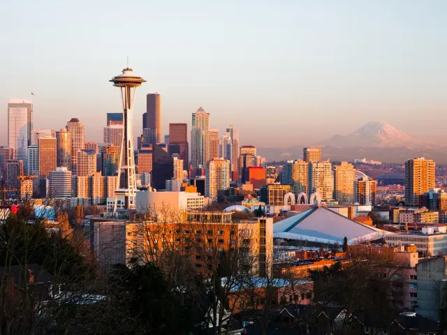 Seattle skyline during sunset with Space Needle in view and mountain in the background
