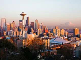 Seattle skyline during sunset with Space Needle in view and mountain in the background