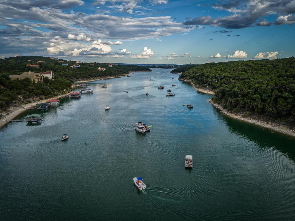 Aerial view of Lake Travis scattered with boats and visitors enjoying water sports, in Austin, Texas 