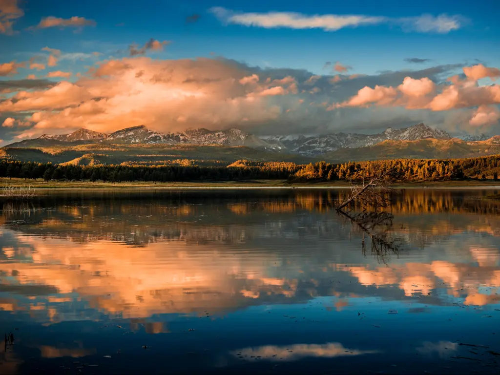 Pagosa Springs, Colorado, USA with the San Juan Mountains in the background taken at sunset and reflected in a lake outside of Pagosa Springs, Colorado.
