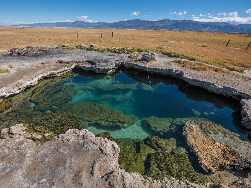 A natural hot springs pool, panoramic shot shot at sunset