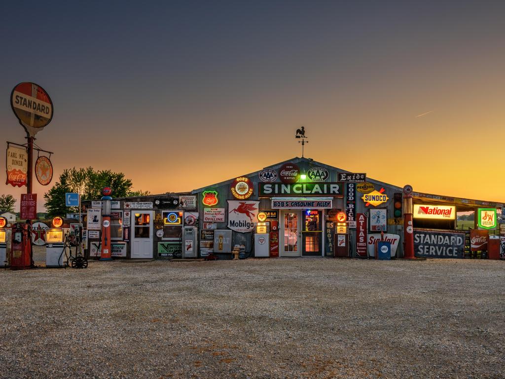 Gasoline Alley Outdoor and indoor collection of over 300 service station signs in Cuba, Missouri at dusk