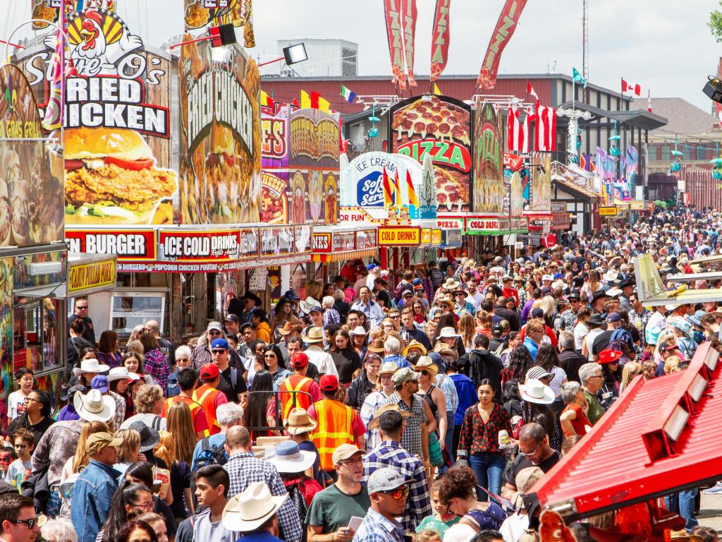 A very crowded street during the famous Calgary Stampede with many food shops and stalls lining the road