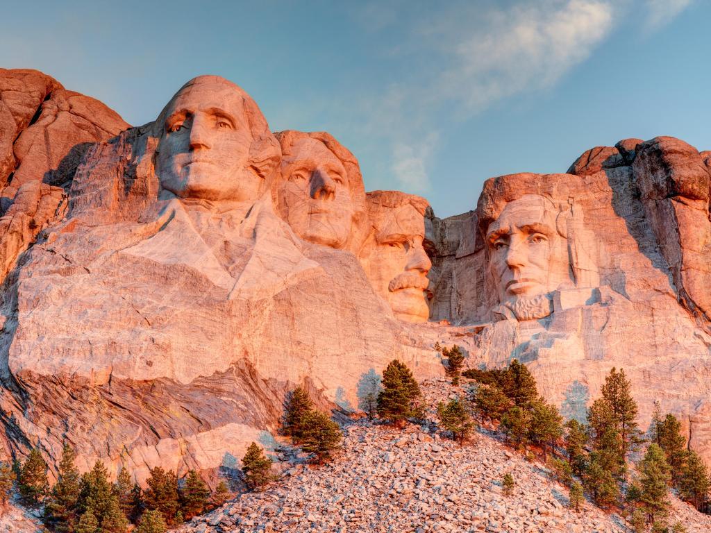 Mount Rushmore National Park in the Black Hills South Dakota during a warm sunrise with clear blue sky morning. 