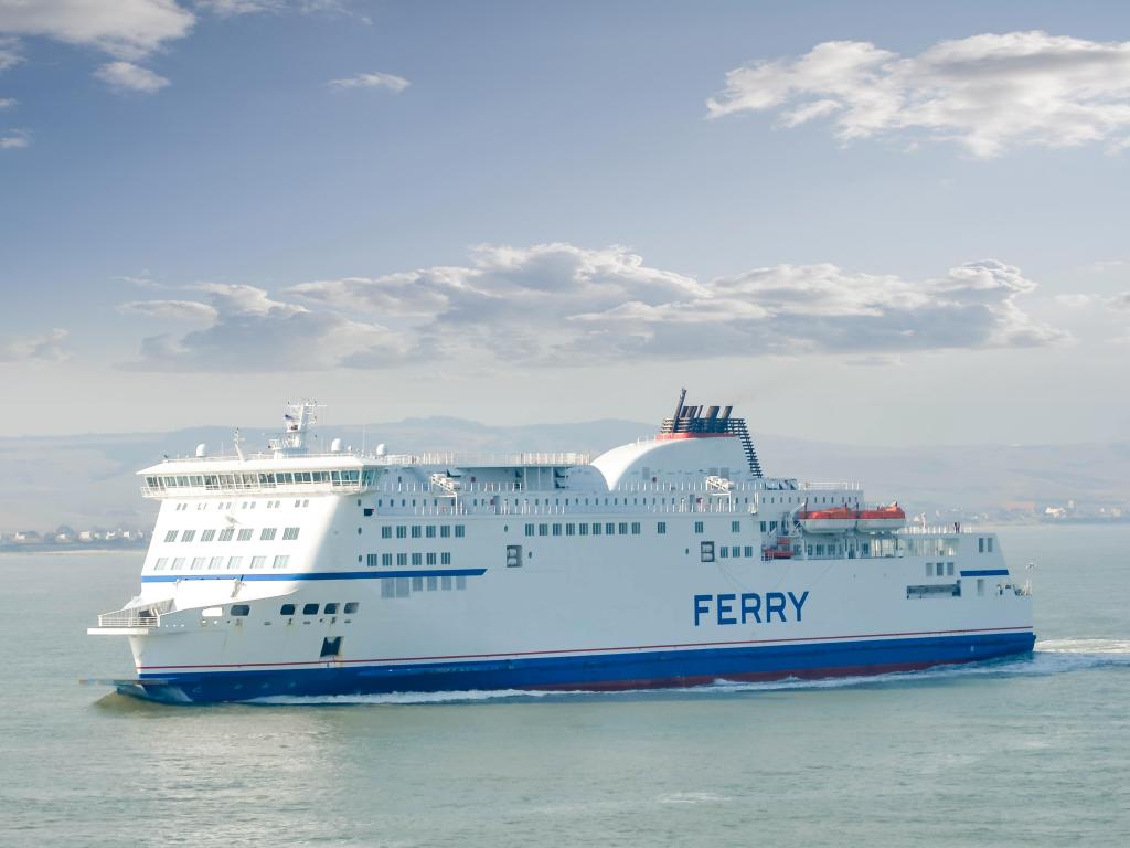 Ferry sailing between Calais and Dover on a cloudy day