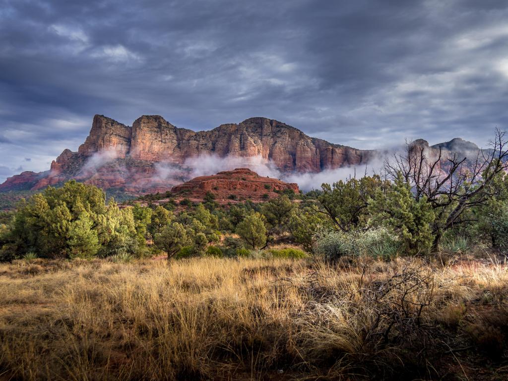 Low Clouds hanging around the Red Rocks the Munds Mountain after a heavy rainfall near the town of Sedona in northern Arizona in Coconino National Forest, USA