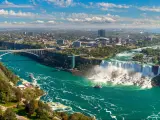Panoramic aerial view of Niagara Falls with a blue sky above