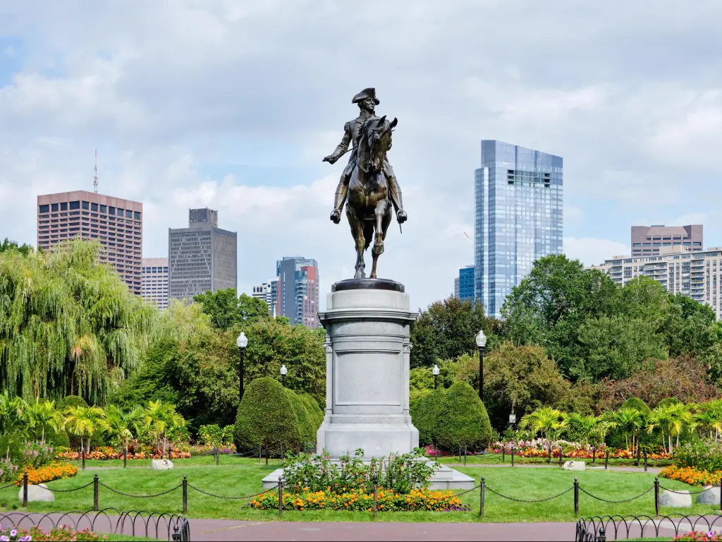 George Washington Monument at Public Garden in Boston, Massachusetts, USA with buildings in the distance.