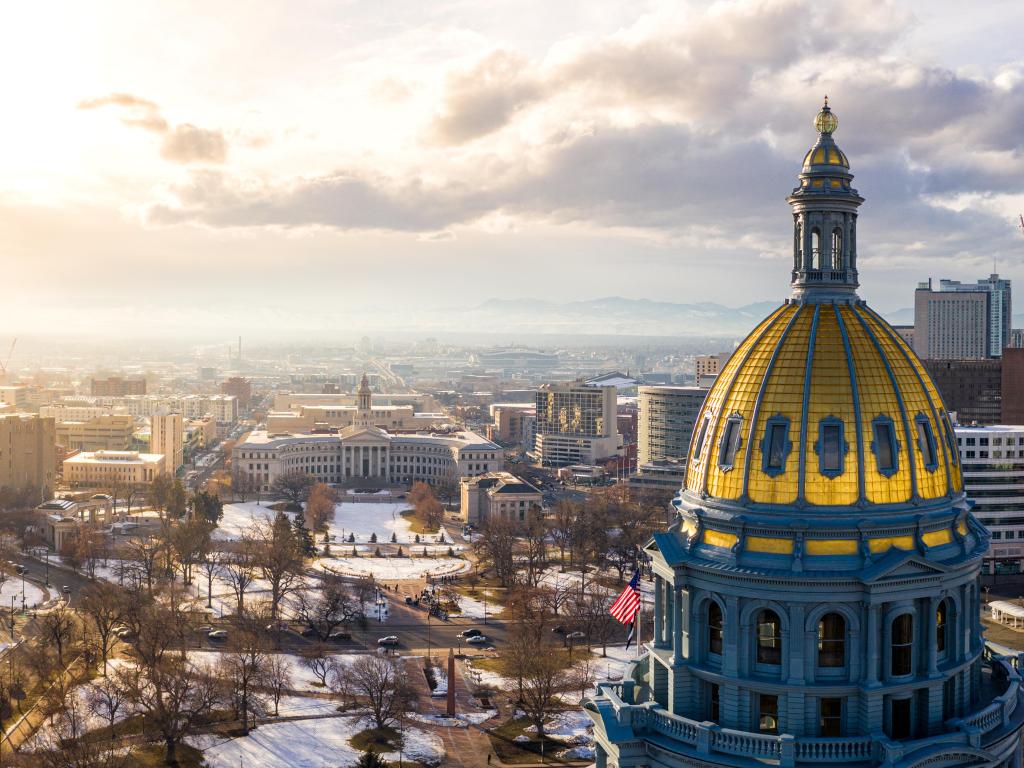 Denver, Colorado, USA with a view of the Colorado State Capitol Building and the city of Denver at Sunset. Rocky Mountains on the horizon.