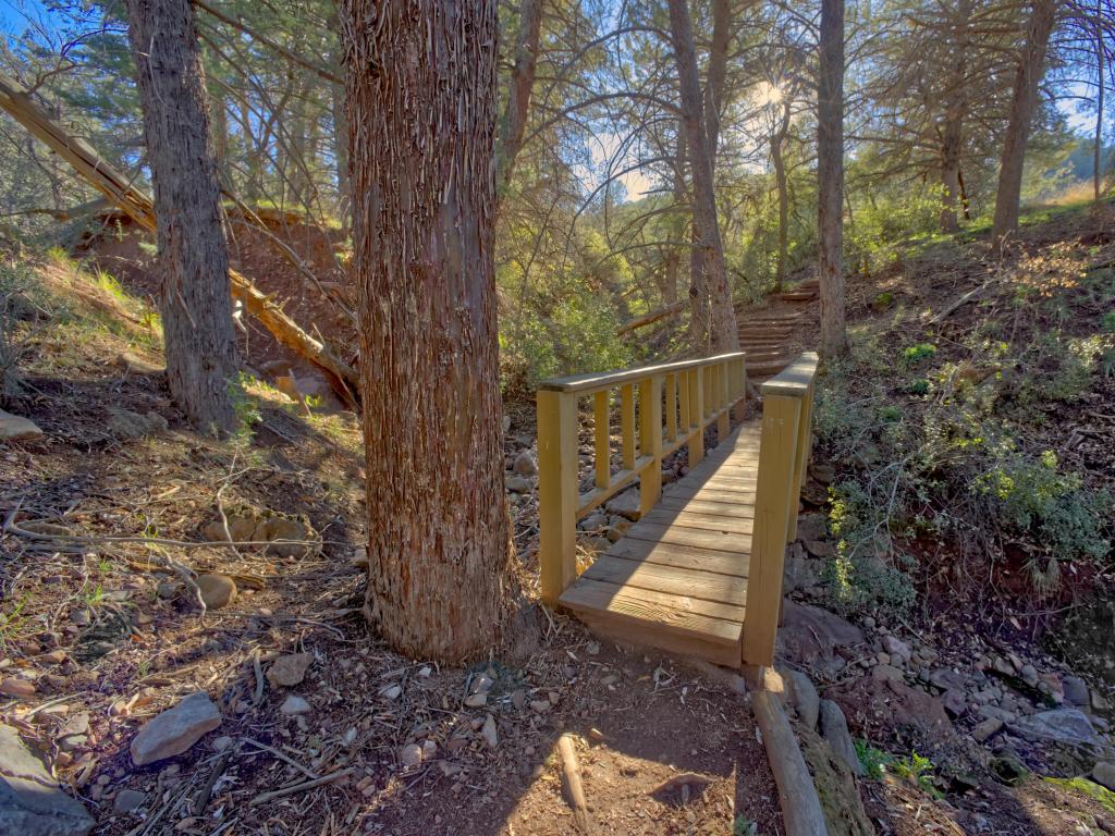 A wooden bridge crossing a drainage creek along the Pine Creek Trail in Tonto Natural Bridge State Park Arizona.