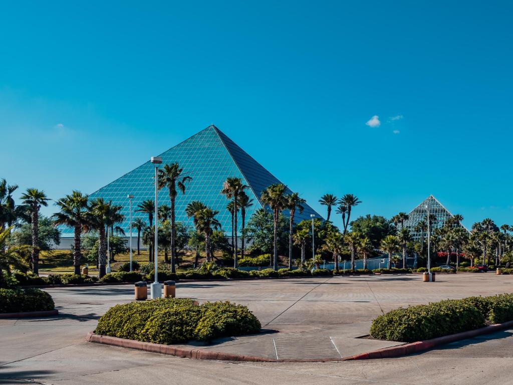 The glass pyramids of the Moody Gardens Aquarium in Galveston, photo taken on a sunny day with blue skies.