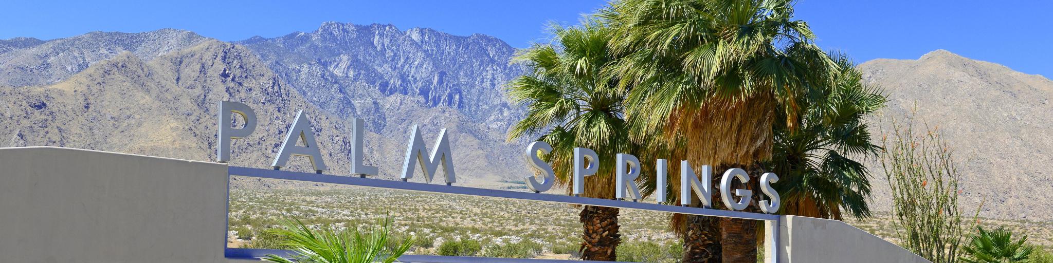 Palm Springs sign with desert background and backdrop of San Jacinto Mountain, California