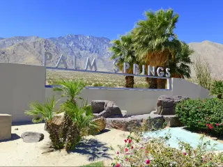 Palm Springs sign with desert background and backdrop of San Jacinto Mountain, California