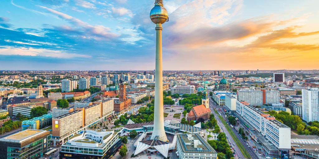 Aerial view of Berlin skyline with famous TV tower at Alexanderplatz and dramatic cloudscape at sunset, Germany