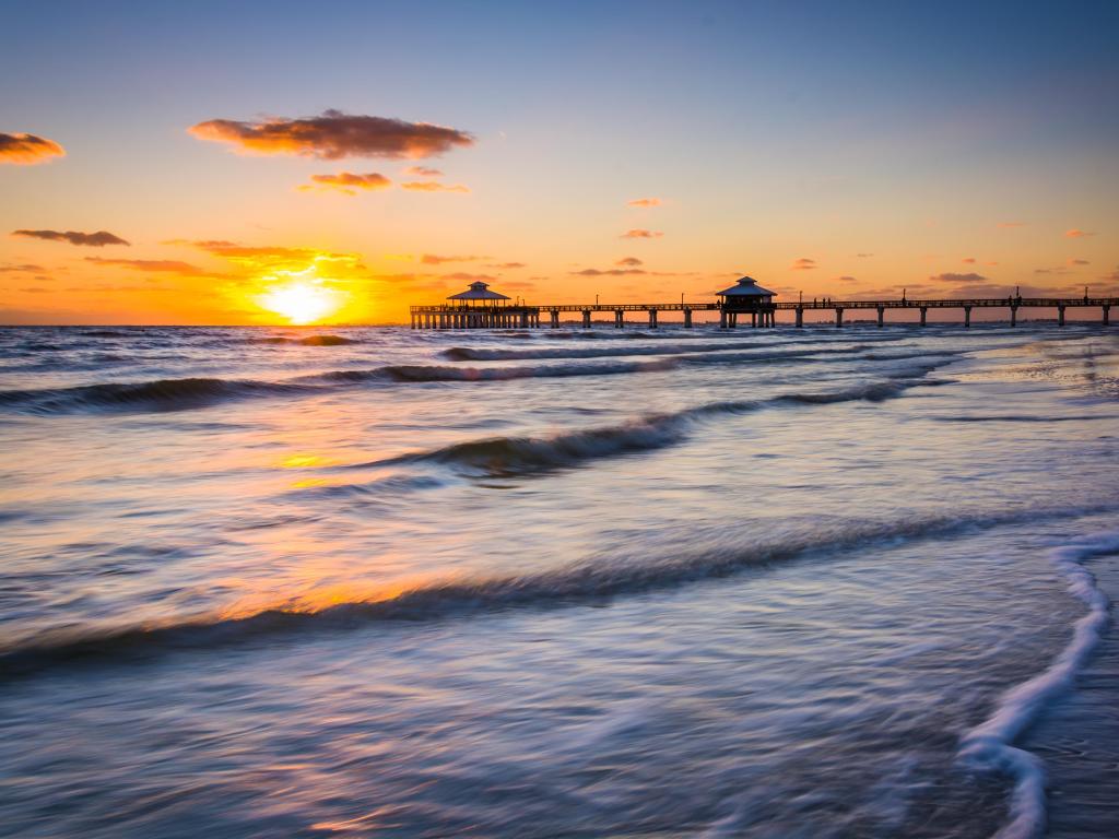 Fort Myers Beach, Florida, USA with a sunset over the fishing pier and Gulf of Mexico.