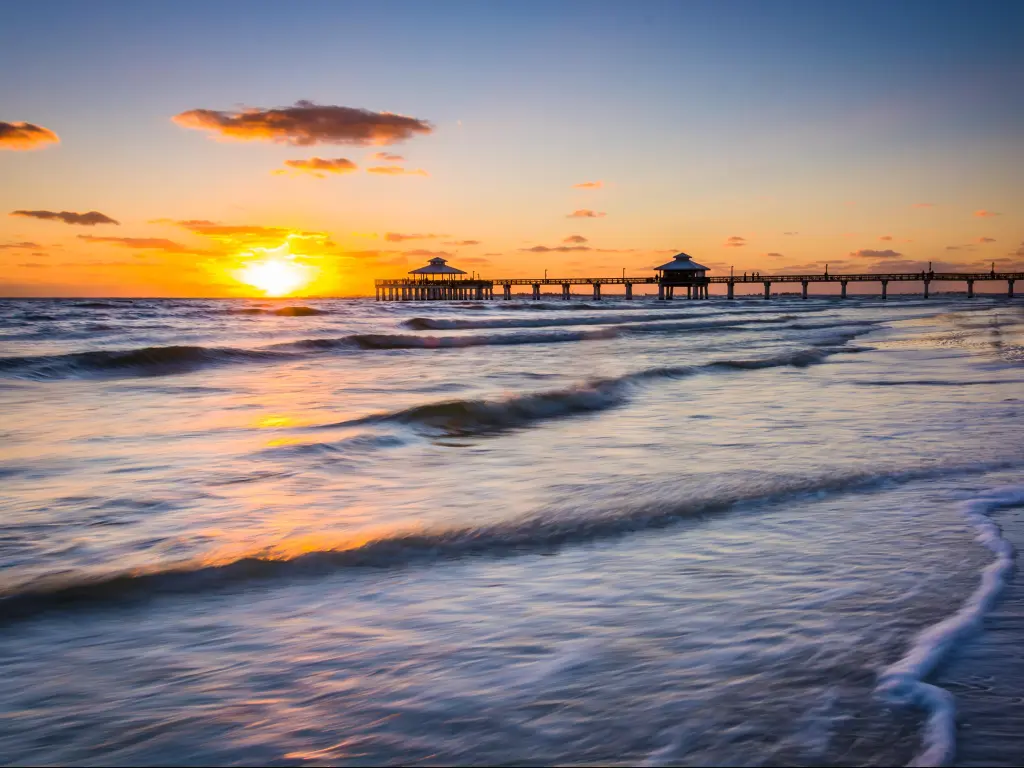 Fort Myers Beach, Florida, USA with a sunset over the fishing pier and Gulf of Mexico.