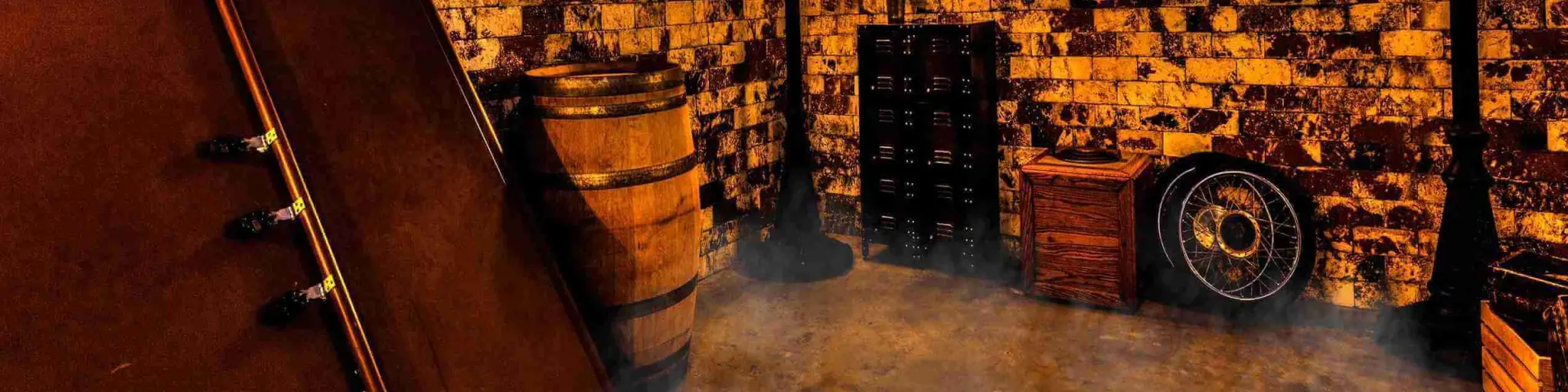Inside dungeon style themed room with smoke effects, within Escape Room Palm Springs