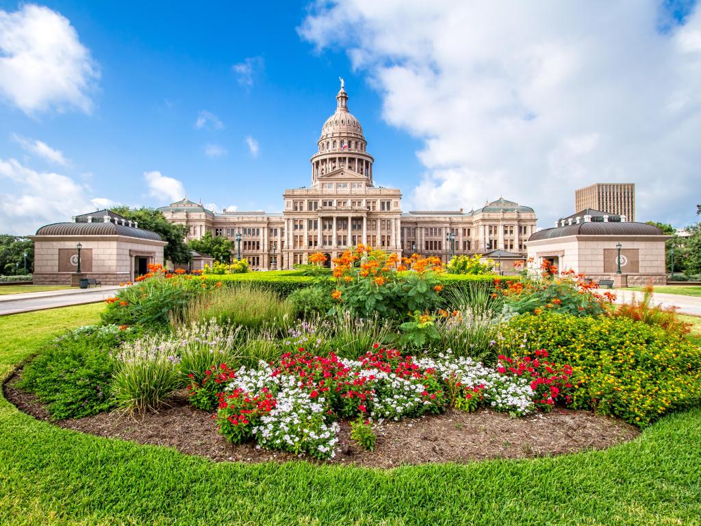 The Texas State Capitol with flower garden