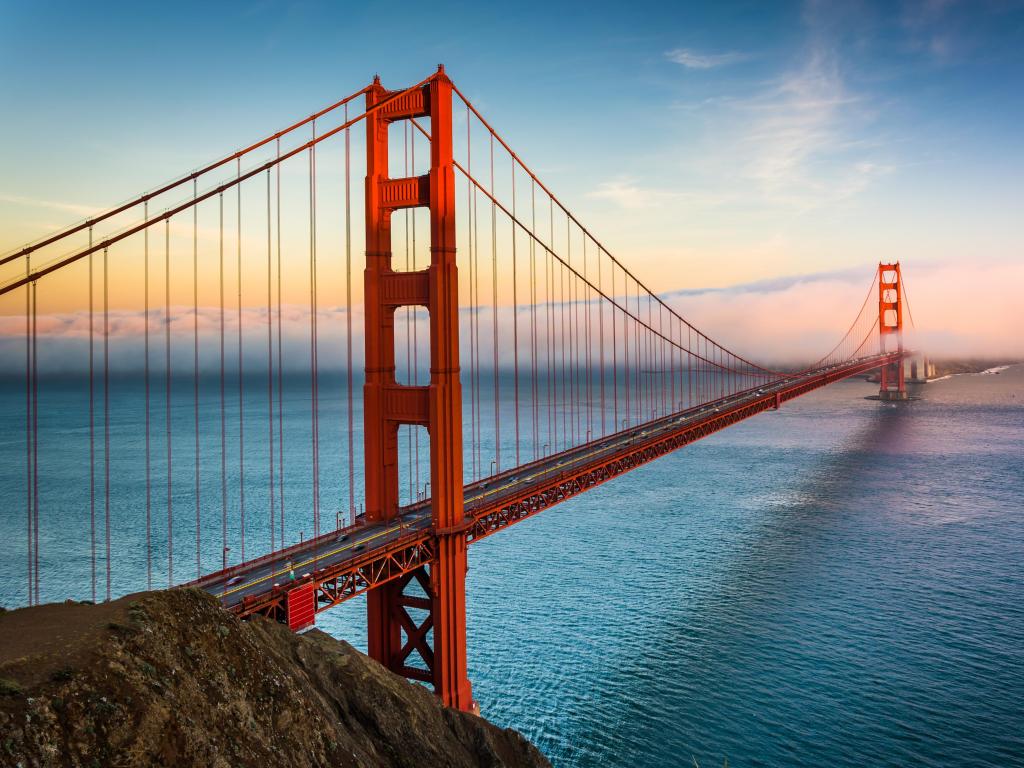 Sunset view of the Golden Gate Bridge and fog from Battery Spencer, Golden Gate National Recreation Area, in San Francisco, California.