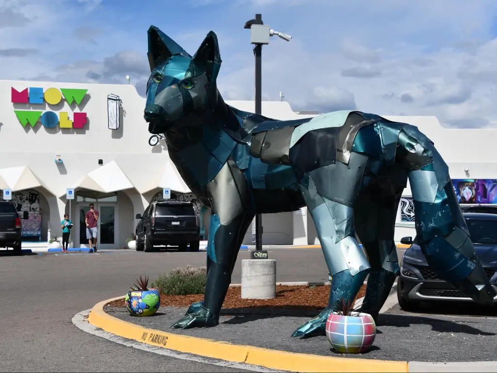 Meow Wolf House of Eternal Return in Santa Fe, New Mexico with a wolf statue in the foreground