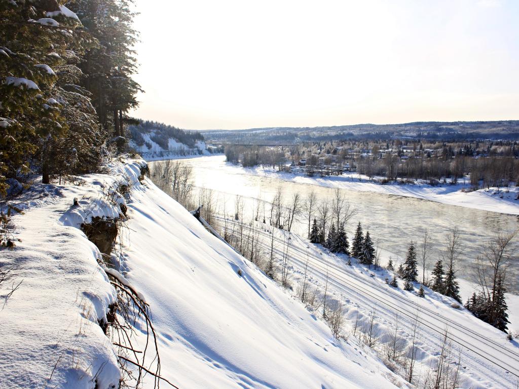 Prince George, British Columbia, Canada taken on a winters day with snow on the hills and the lake frozen with the town beyond in the distance. 