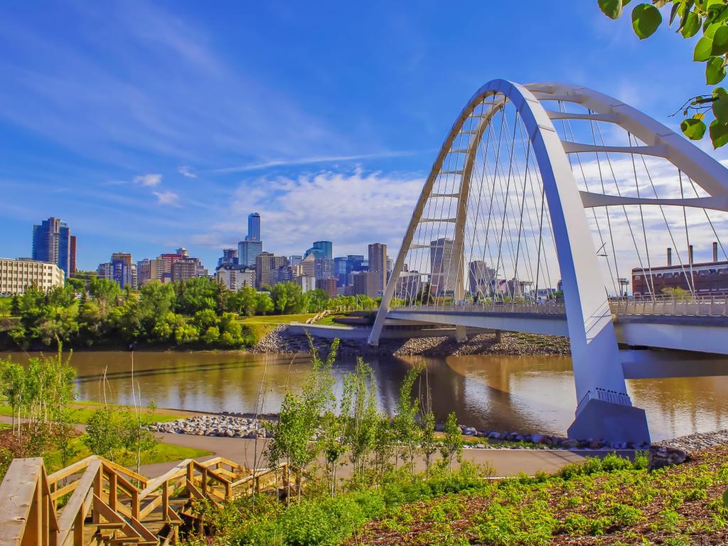 Edmonton, Canada taken with downtown Edmonton taken at River Valley with the steel bridge in the foreground and taken against a blue sky.