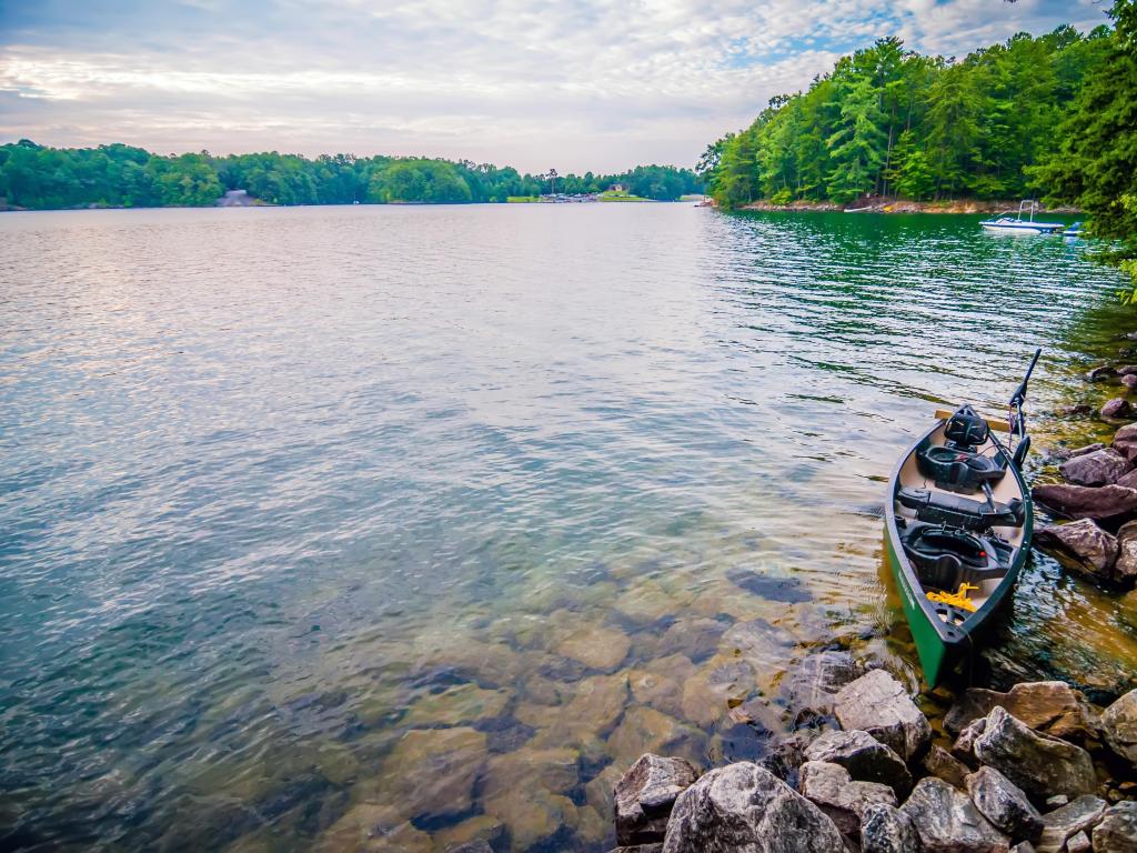 Lake Murray, Columbia, South Carolina with a kayak close to rocks on the lake.