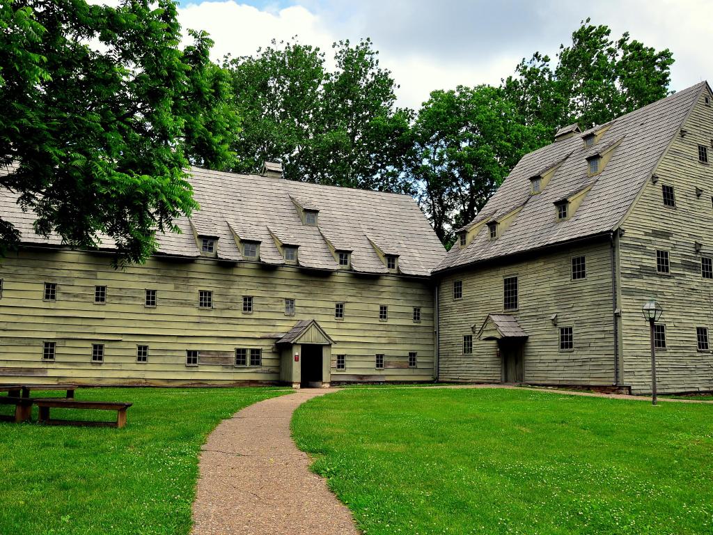 The wooden 1743 Saron (Sisters' House) on left and 1741 fachwerk Saal (Meeting House) at the Ephrata Cloister on the right on a cloudy day