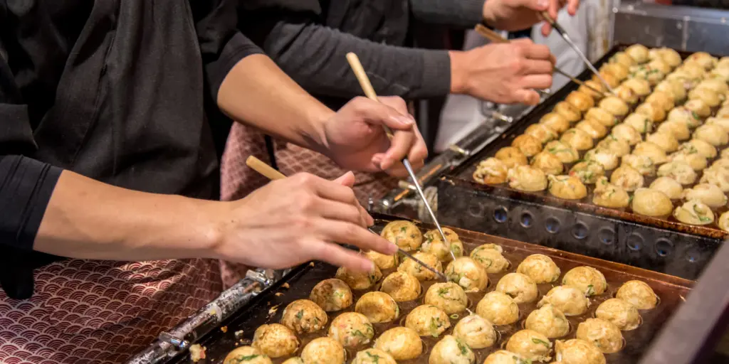 Chefs making takoyaki in Osaka 