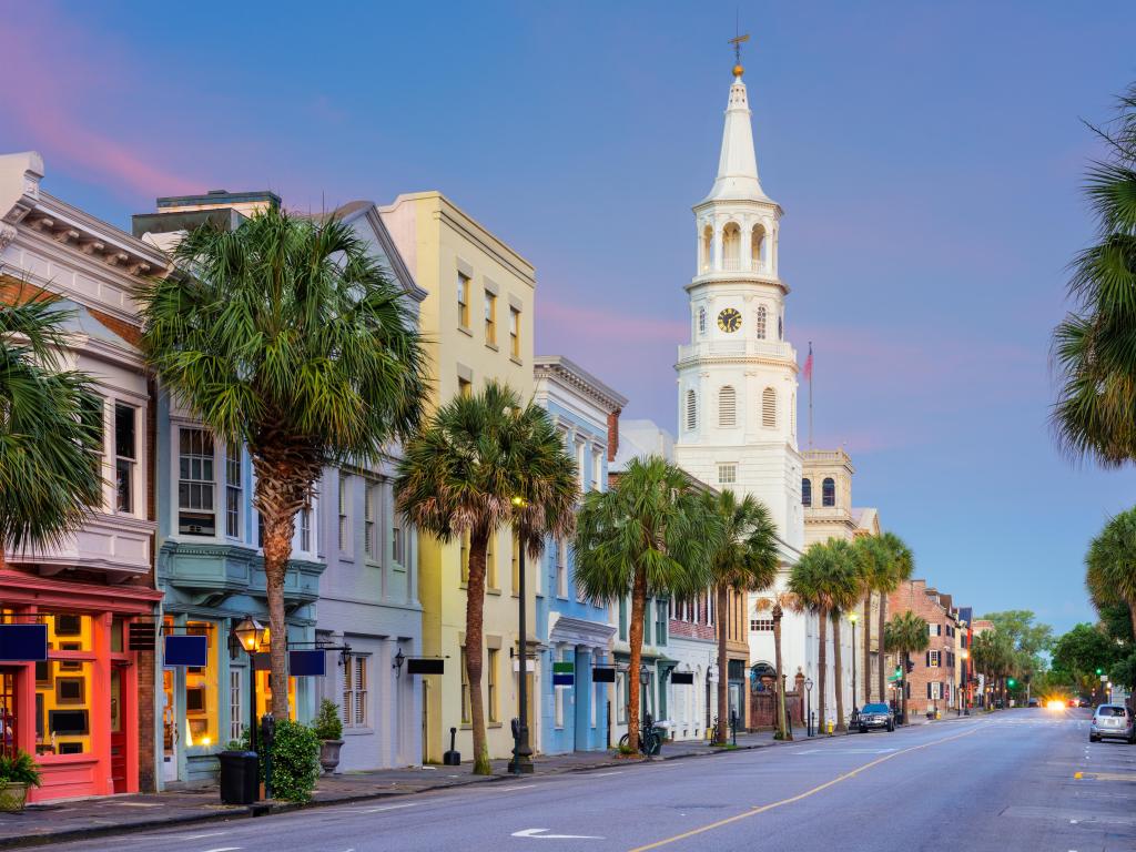 Charleston, South Carolina, USA with a row of colorful buildings and palms trees in the French Quarter taken at early evening.