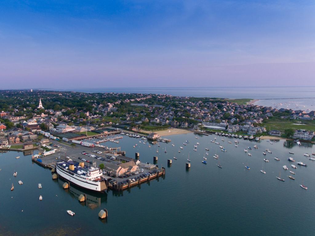 An aerial view of the Nantucket Island Harbor with sailboats and houses.