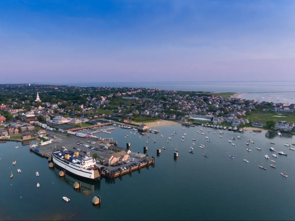 An aerial view of the Nantucket Island Harbor with sailboats and houses.